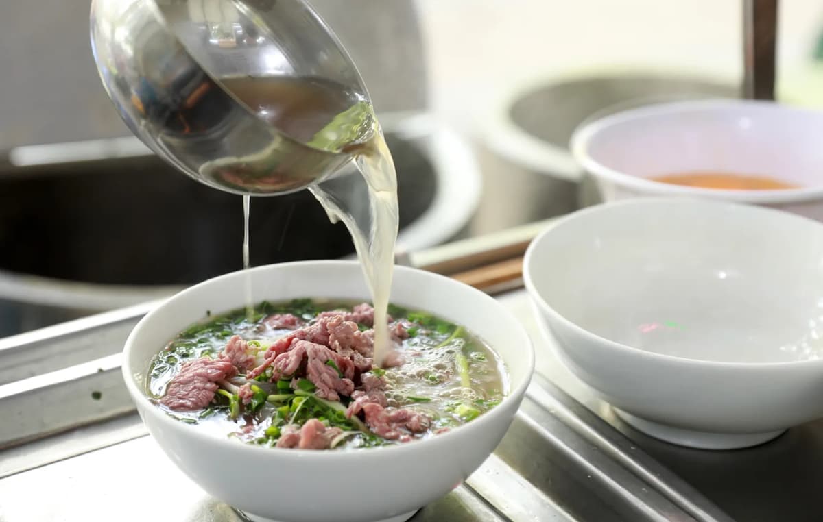 The broth is slow-cooked with spices like star anise, cinnamon, and cloves for a rich aroma